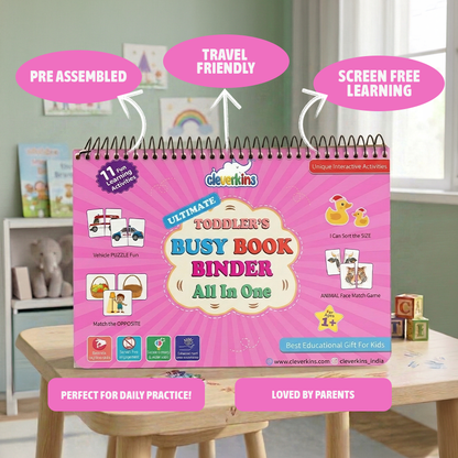 Pink 'Toddler's Busy Book Binder' on a table with educational toys in the background
